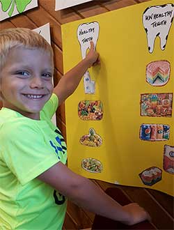 Royce Smiles at Healthy Teeth